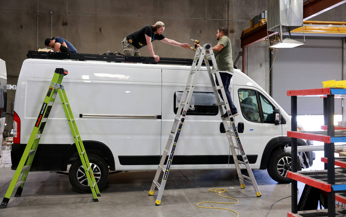 Workers convert a van into a mobile home at Noovo manufacturing facility in Las Vegas Thursday, ...