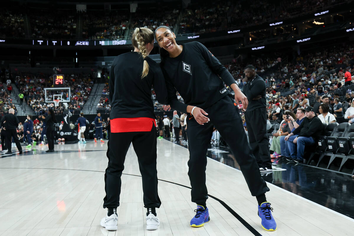 Las Vegas Aces guard Kate Martin, left, and center A'ja Wilson bump heads and quote “Fin ...