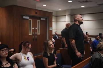 A man who declined to be named stands up next to family and friends and addresses the judge dur ...