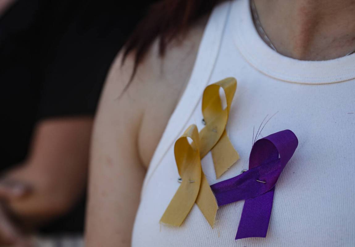 Family friend Rae H. shows ribbons commemorating Rebecca Post and her two young sons Achilles Q ...