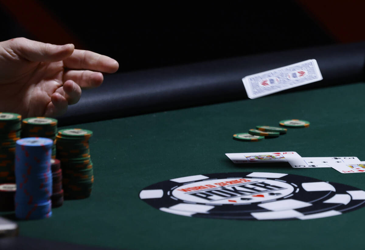 A poker player surrenders during the first day of the World Series of Poker Main Event at Horse ...