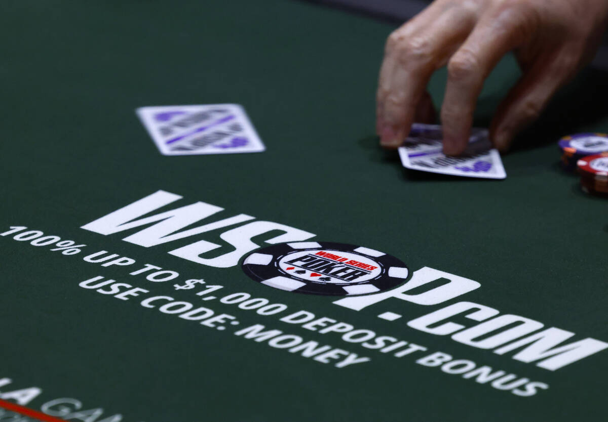 A poker player participates during the first day of the World Series of Poker Main Event at Hor ...