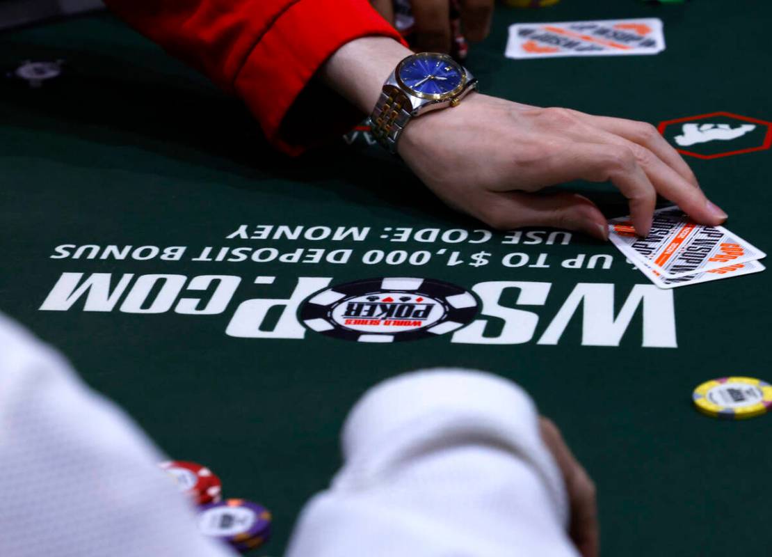 A poker player surrenders during the first day of the World Series of Poker Main Event at Horse ...