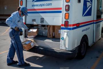 United States Postal Service mail carrier Lizette Portugal finishes up loading her truck on Apr ...