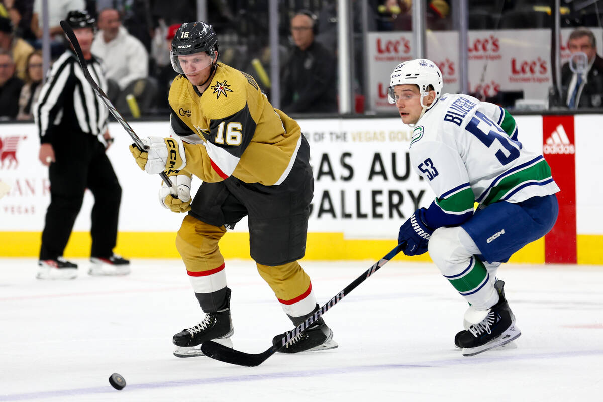 Golden Knights left wing Pavel Dorofeyev (16) skates for the puck against Canucks center Teddy ...