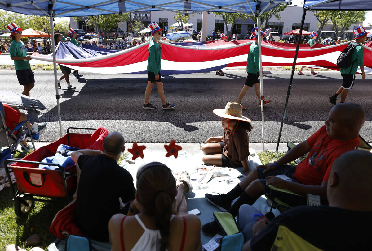 People watch as students from Palo Verde High School carry a giant American Flag during the ann ...