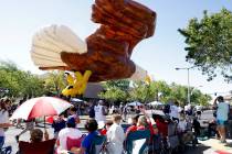 A giant eagle ballon is flying over people during the annual Summerlin Council Patriotic Parade ...