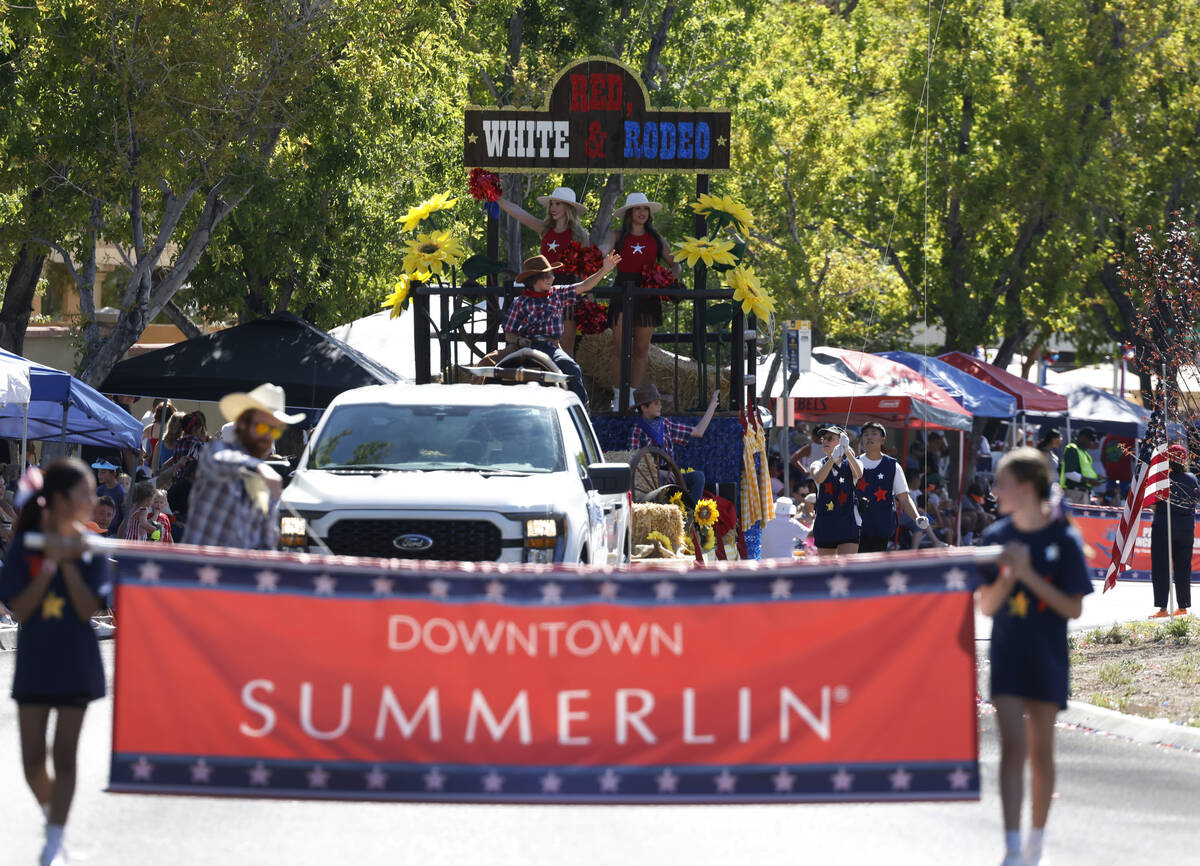 Participants perform on the Red White and Rodeo float during the annual Summerlin Council Patri ...