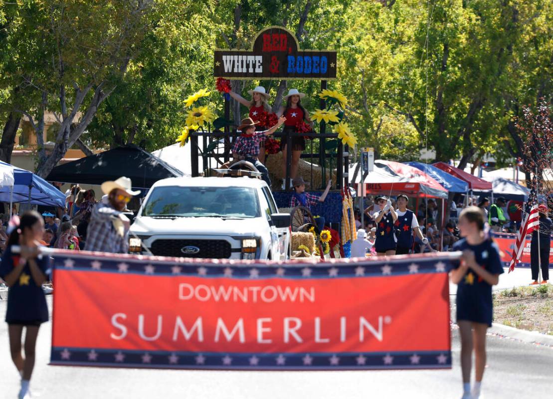 Participants perform on the Red White and Rodeo float during the annual Summerlin Council Patri ...