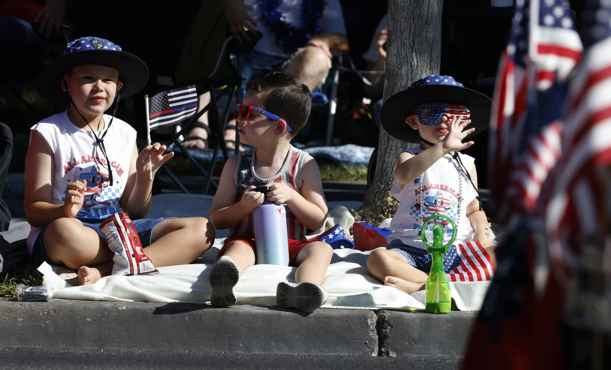 Hudson Hunter, left, 8, and his brother Caden, 3, right, watch the annual Summerlin Council Pat ...