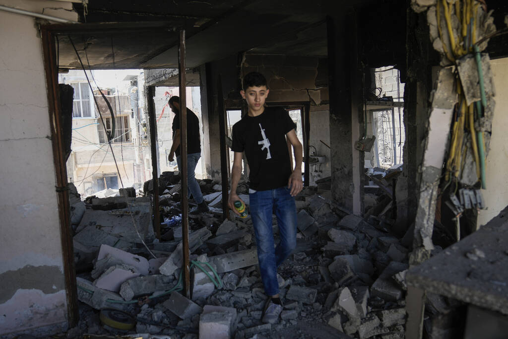 Palestinians inspect the destruction following an Israeli operation in Nur Shams refugee camp, ...