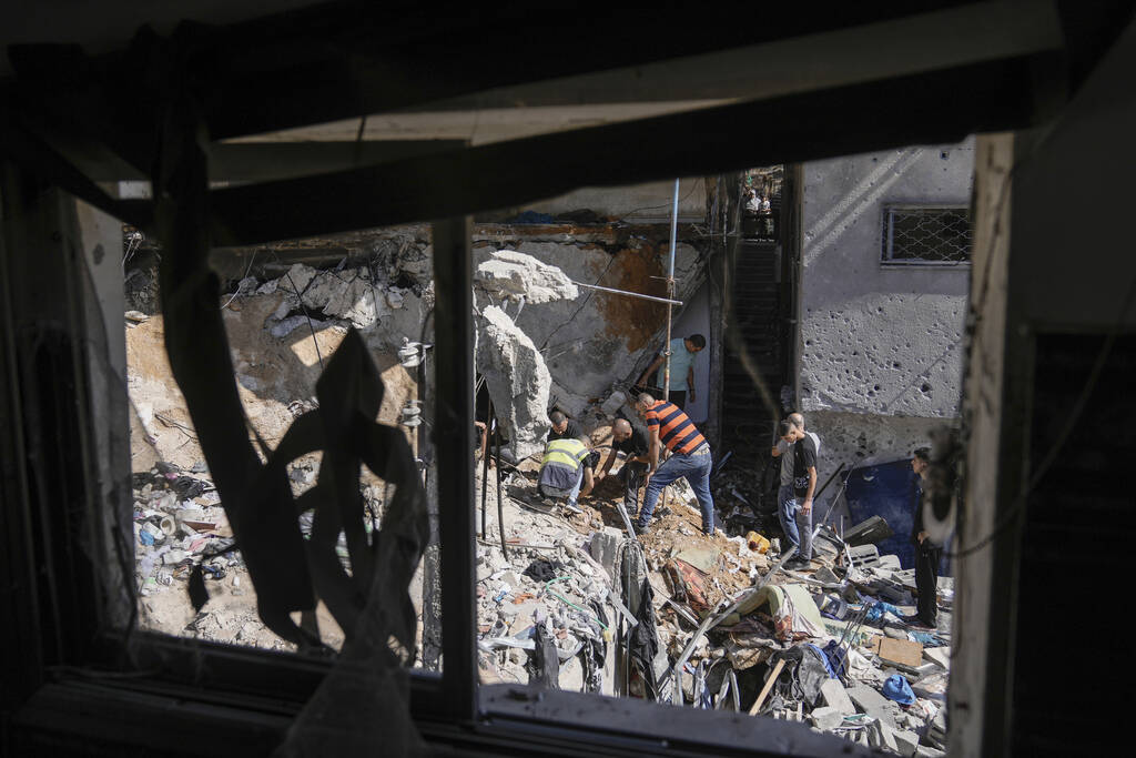 Palestinians inspect the destruction following an Israeli operation in Nur Shams refugee camp, ...