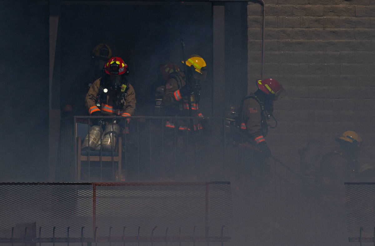 Clark County firefighters work to contain an apartment fire on Dumont Boulevard on Wednesday, J ...