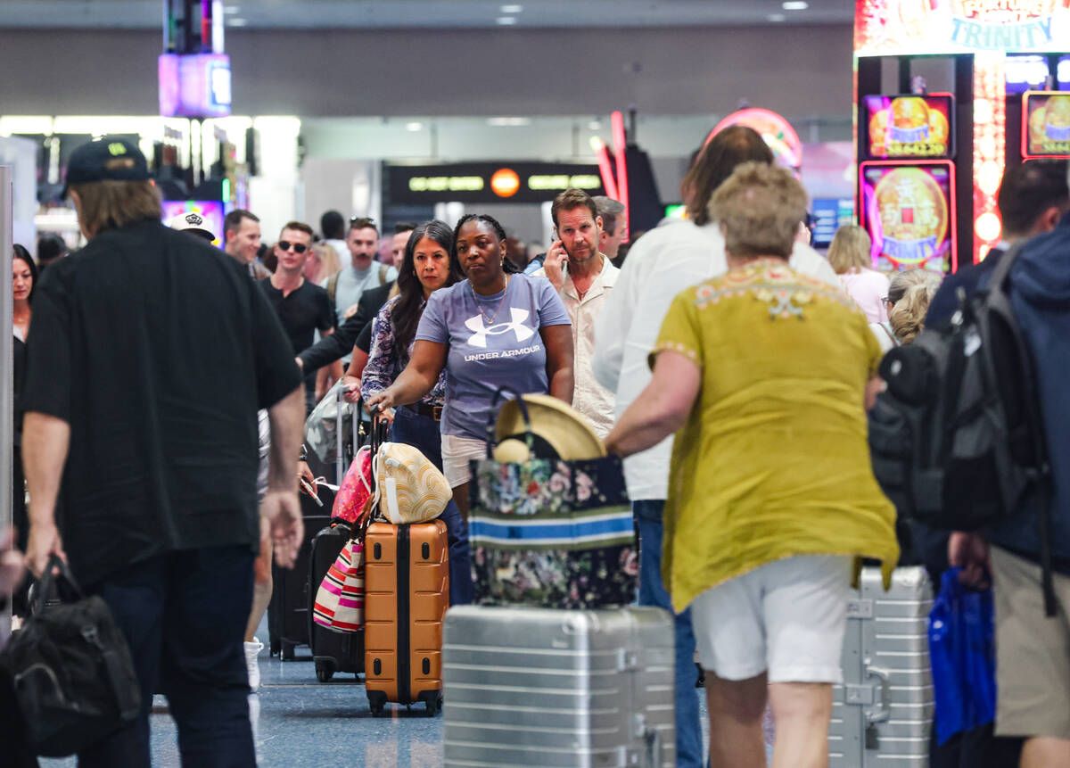 Guests pass through the baggage claim area of Harry Reid International Airport in Las Vegas, We ...