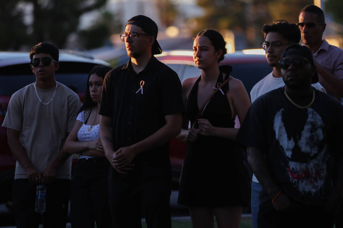 Alex Rivera, center left, 20, and Angelica Rivera, center right, 21, pause during a vigil for t ...