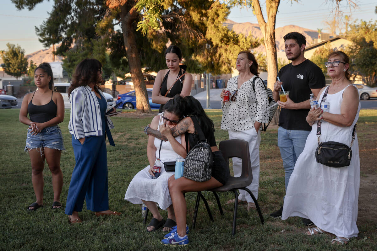 Loved ones of Alondra Rivera, 28, embrace during a vigil at Winterwood Park on Wednesday, July ...