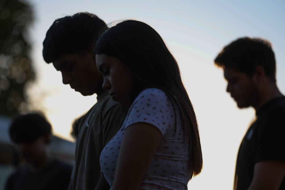 Loved ones of Alondra Rivera pray during a vigil at Winterwood Park on Wednesday, July 3, 2024, ...