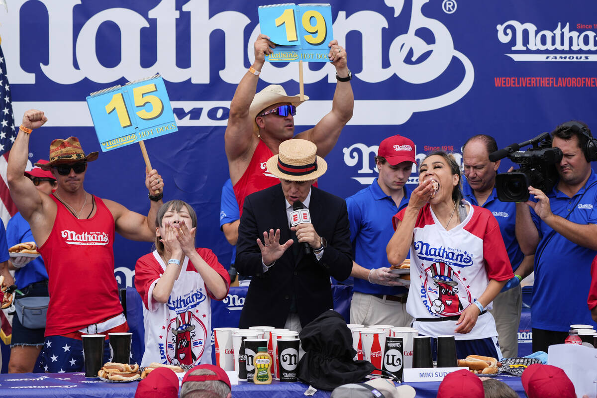 Miki Sudo, right, and Mayoi Ebihara, left, compete in the women's division of Nathan's Famous F ...