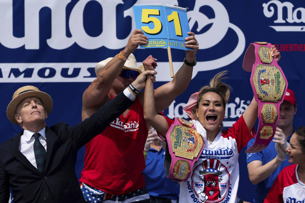 Miki Sudo, right, reacts after winning the women's division in the Nathan's Famous Fourth of Ju ...