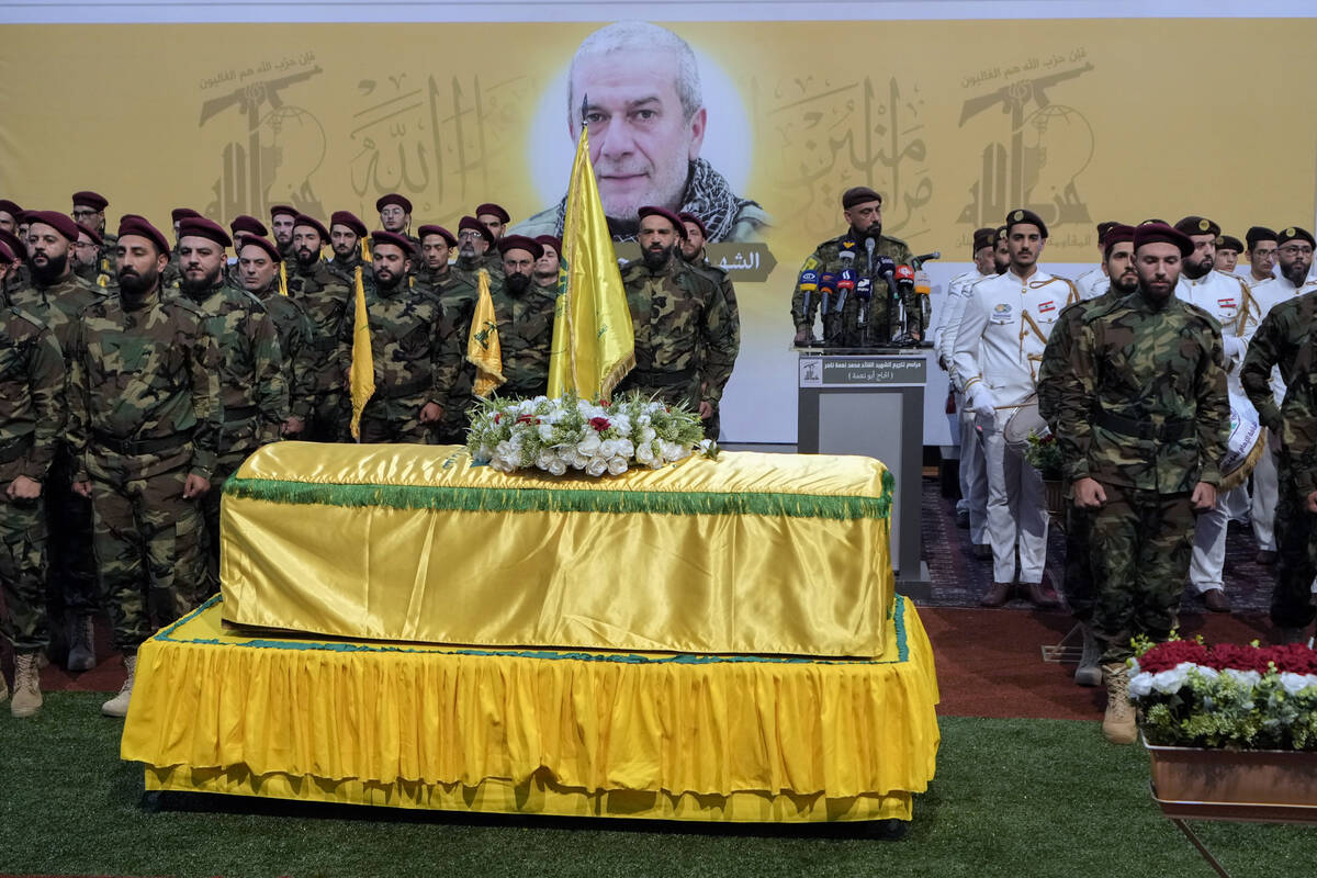 Hezbollah fighters attend the funeral procession of their comrade, senior commander Mohammad Na ...
