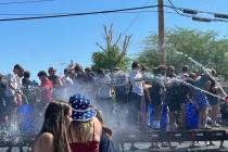 Kids exchange water gun fire during Boulder City's Independence Day parade on July 4, 2024 (Nob ...