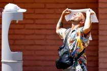 Buddy Willer of Las Vegas uses a wet towel to cool himself at Lorenzi Park on a sunny and hot M ...