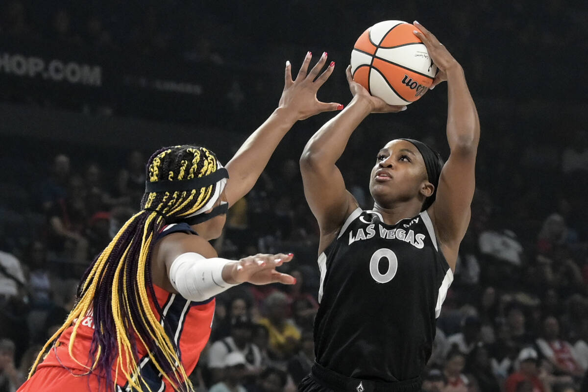 Washington Mystics forward Aaliyah Edwards (24) defends Las Vegas Aces guard Jackie Young (0) d ...