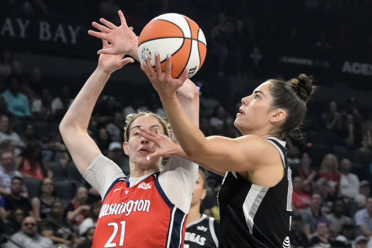 Las Vegas Aces guard Kelsey Plum (10) drives past Washington Mystics forward Emily Engstler (21 ...