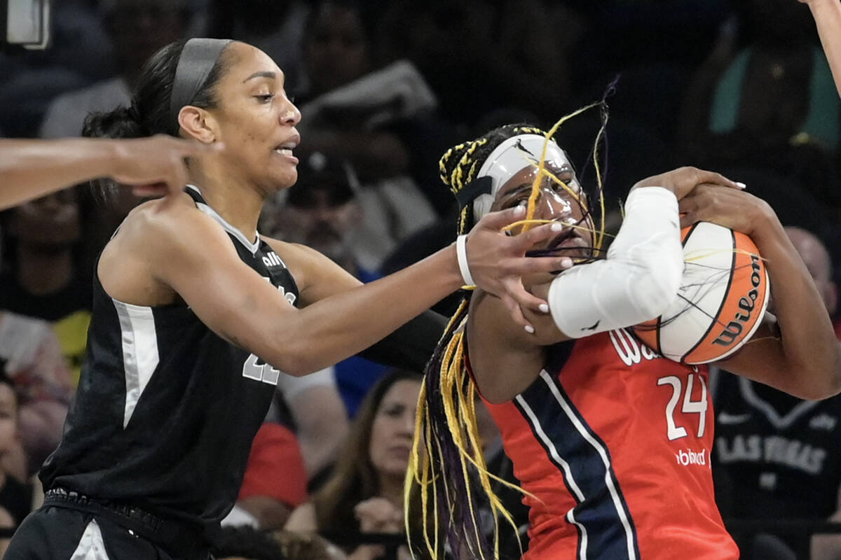 Las Vegas Aces center A'ja Wilson (22) defends Washington Mystics forward Aaliyah Edwards (24) ...