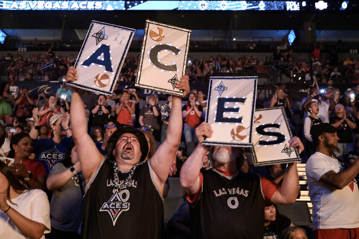 Albert Ronquillo, left, and Matt Schafer cheer on the Aces before the first half of their WNBA ...