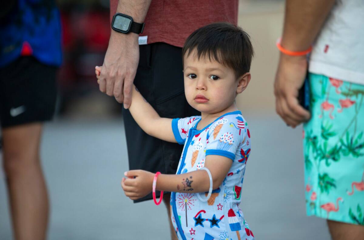 Logan Noworyta, 2, holds his father’s hand while waiting for gelato during the Independence D ...