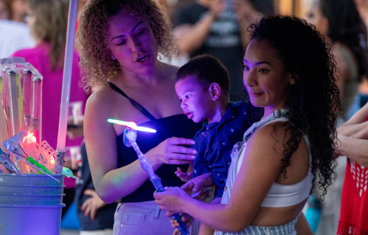 Customers buy glowing toys during the Independence Day celebration at Lake Las Vegas Thursday, ...