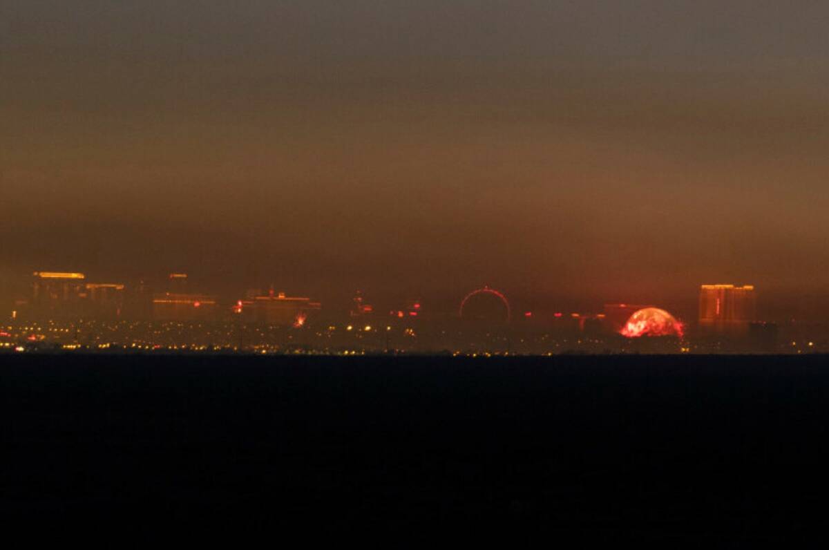 A haze begins to cover the Las Vegas skyline after numerous firework displays were fired off ac ...