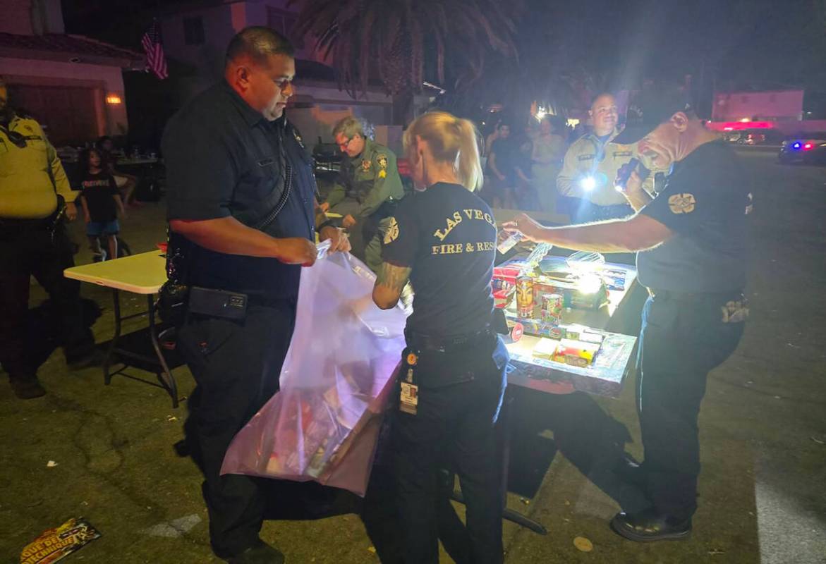 Las Vegas Fire Department firefighters and other officials pack up illegal fireworks on July 4, ...