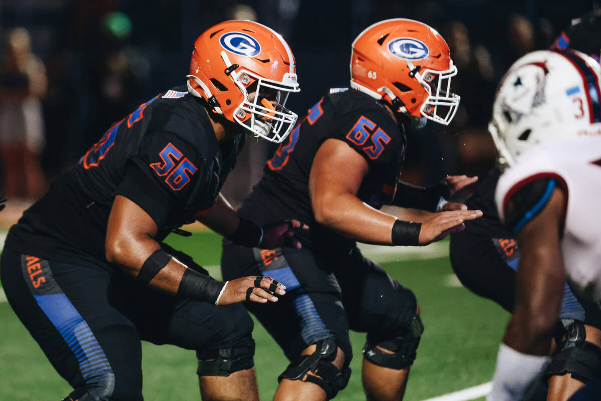 Bishop Gorman offensive linemen Doug Utu (56) and SJ Alofaituli (65) position themselves during ...