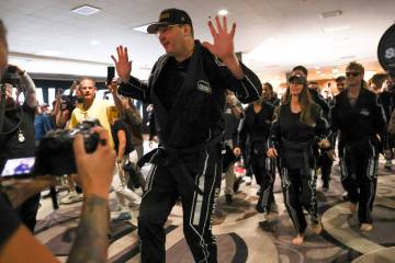 Professional poker player Phil Hellmuth makes a grand entrance to the song “Kung Fu Figh ...