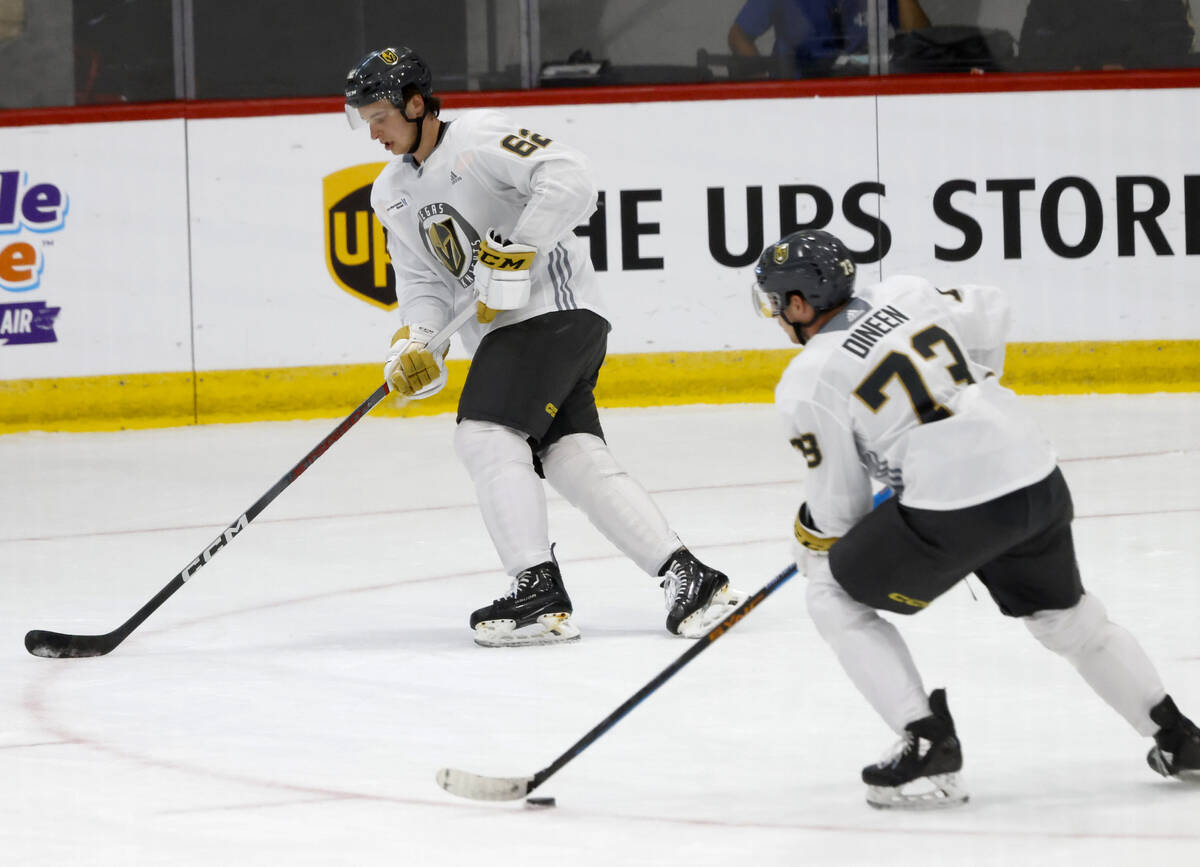 Golden Knights defenseman Noah Ellis (62) and forward Will Dineen (73) skate during team's deve ...