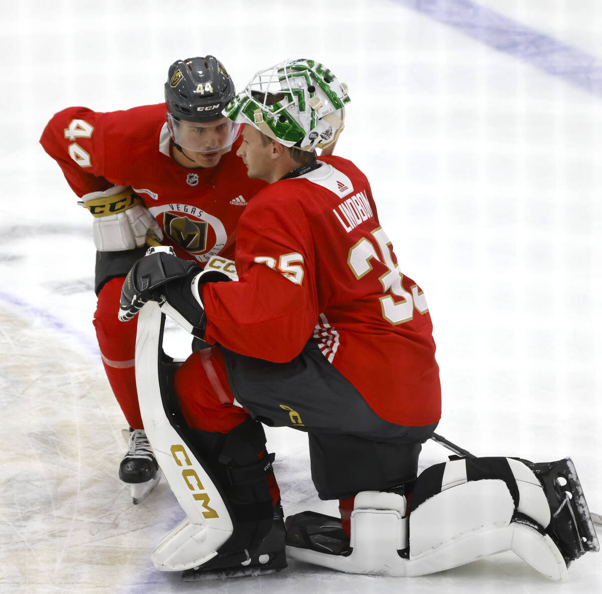 Golden Knights defenseman Christoffer Sedoff and goaltender Carl Lindbom (35) chat during team' ...