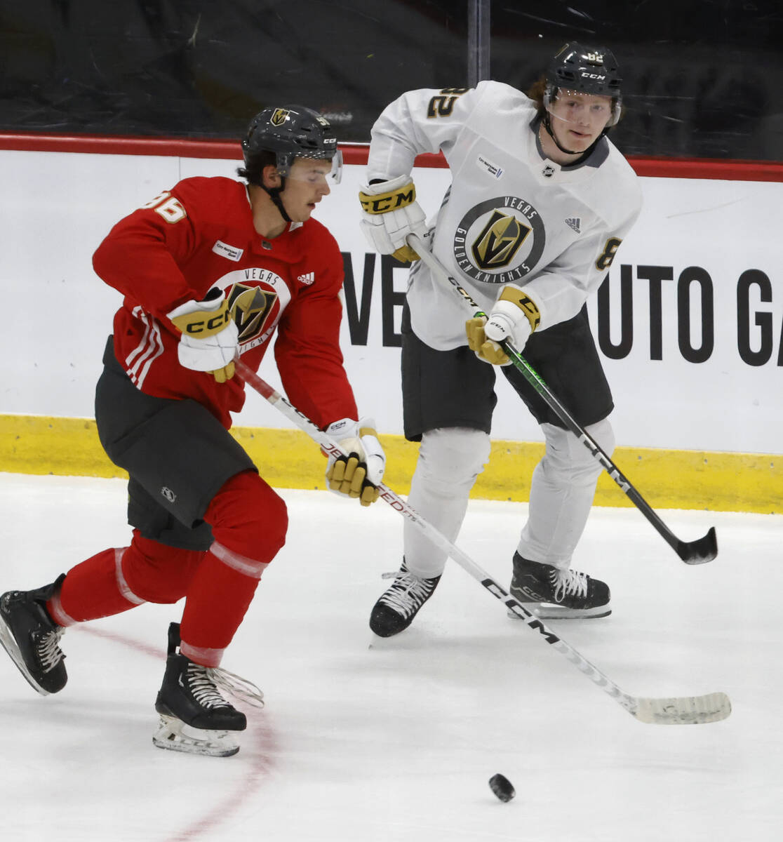 Golden Knights defensemen Samuel Mayer (96) and Abram Wiebe (82) chase the puck during team's d ...