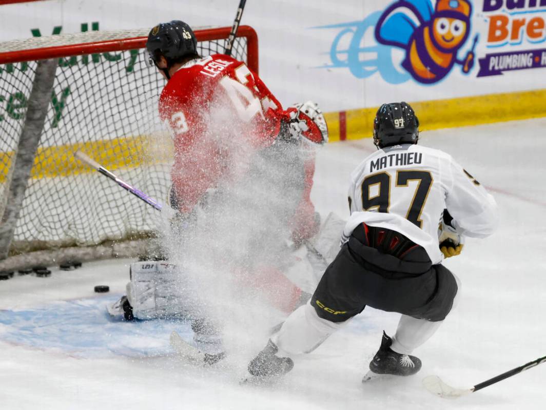 Golden Knights forward Jacob Mathieu (97) scores as defenseman Mazden Leslie (43) and goaltende ...