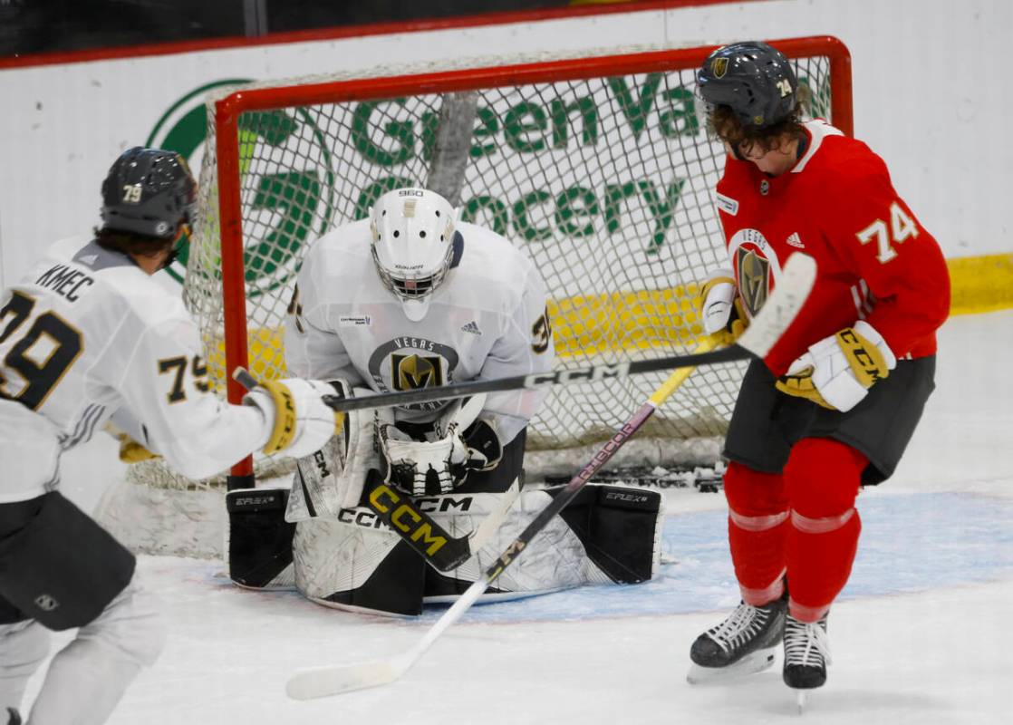 Golden Knights goaltender Jesper Vikman (32) blocks forward Shane Smith's (74) puck during team ...