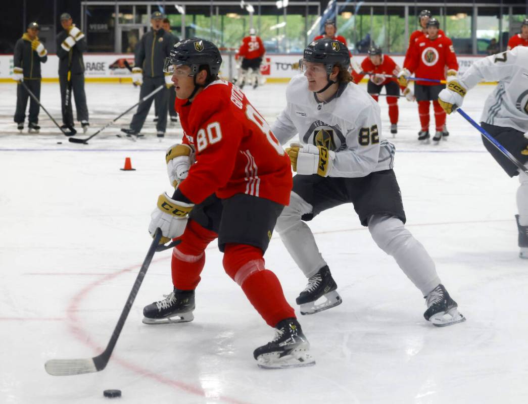 Golden Knights defensemen Lukas Gustafsson (80) and Abram Wiebe (82) skates during team's devel ...