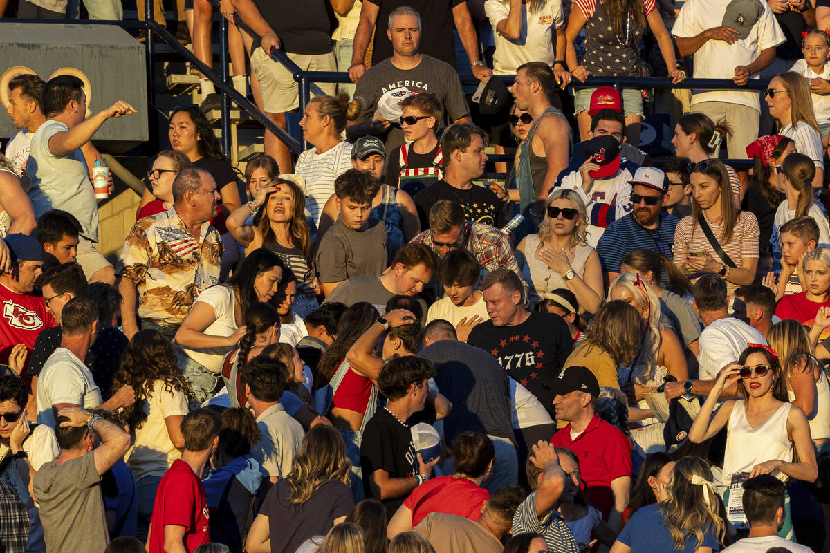 The crowd reacts after an errant firework exploded among attendees during Stadium of Fire held ...