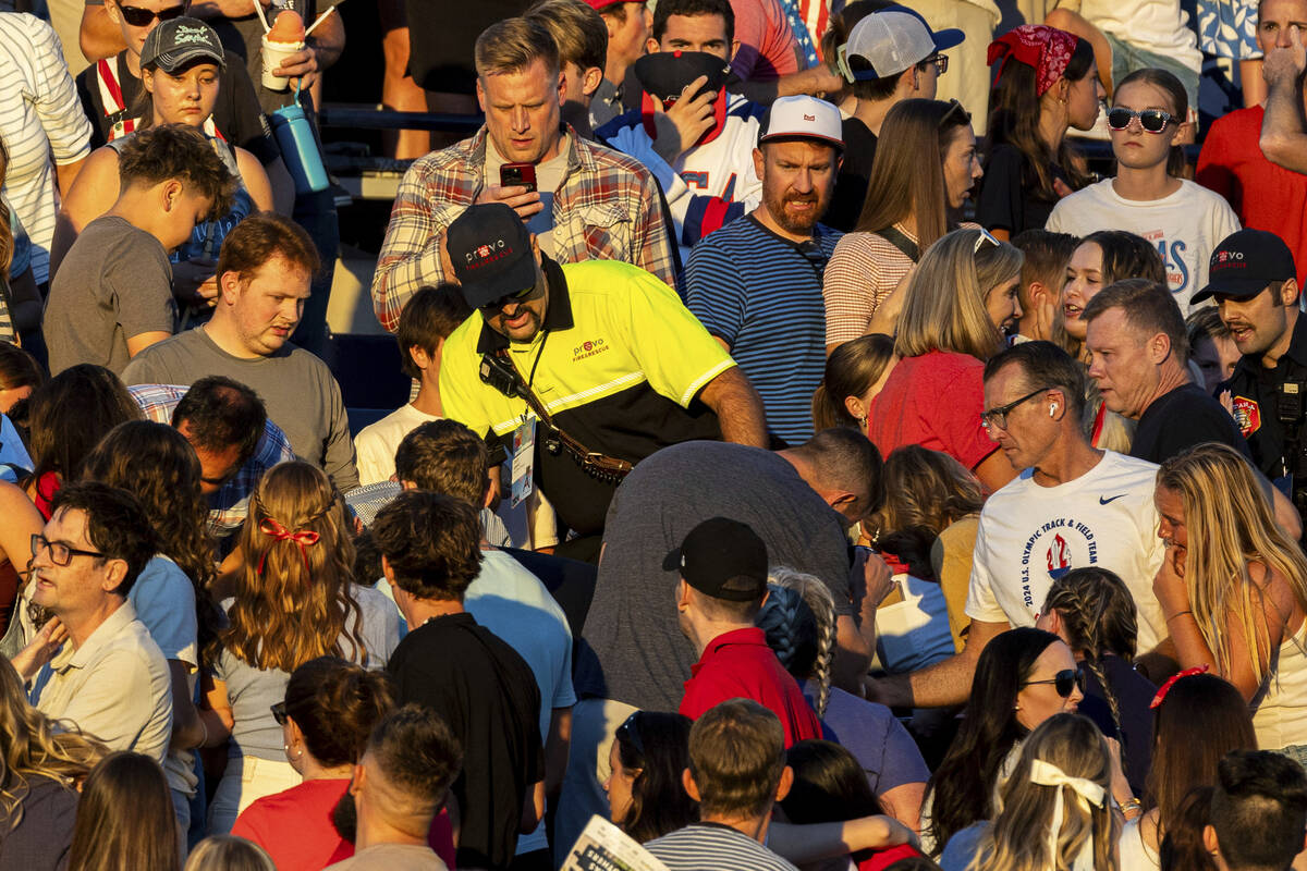 The crowd watches as a member of Provo Fire and Rescue searches for an injured individual after ...