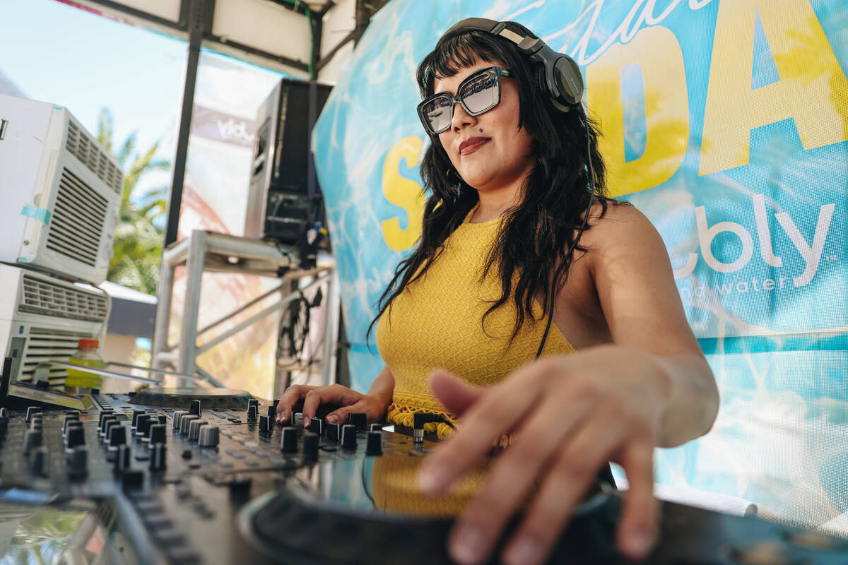 DJ Aravi DJs during Temptation Sundays, an LGBTQ+ pool party at the Luxor pool on Sunday, June ...