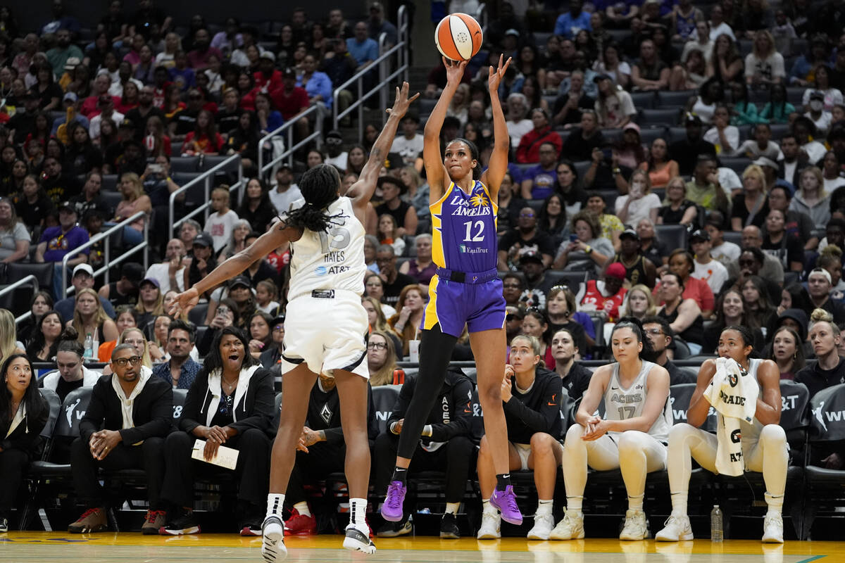 Los Angeles Sparks guard Rae Burrell, right, shoots against Las Vegas Aces guard Tiffany Hayes ...