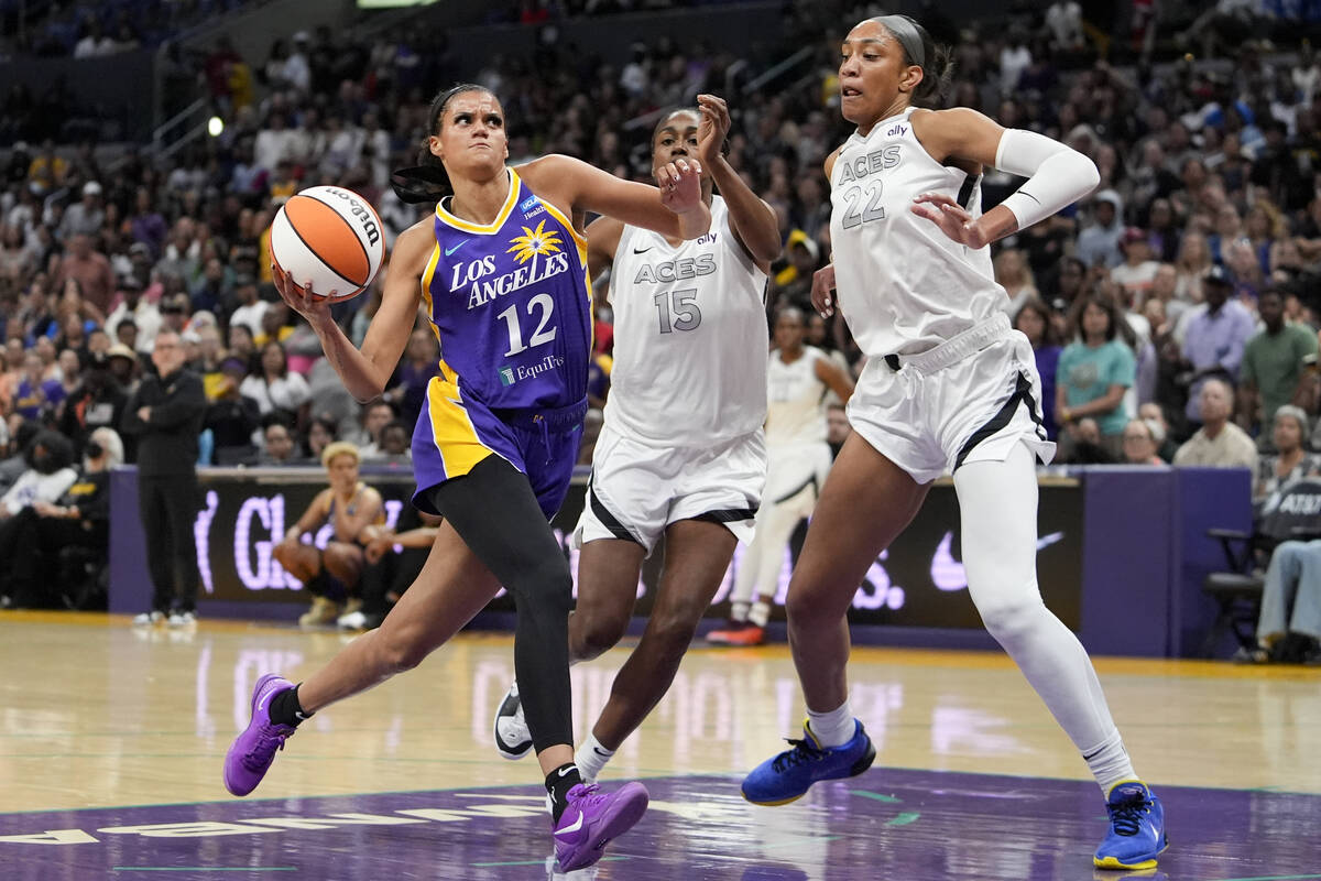 Los Angeles Sparks guard Rae Burrell, left, drives against Las Vegas Aces guard Tiffany Hayes, ...