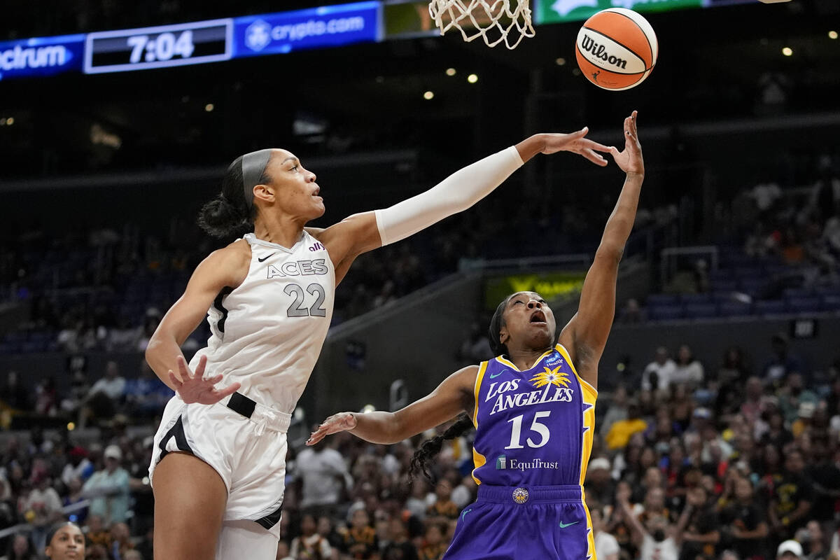 Las Vegas Aces center A'ja Wilson, left, contests a shot by Los Angeles Sparks guard Aari McDon ...