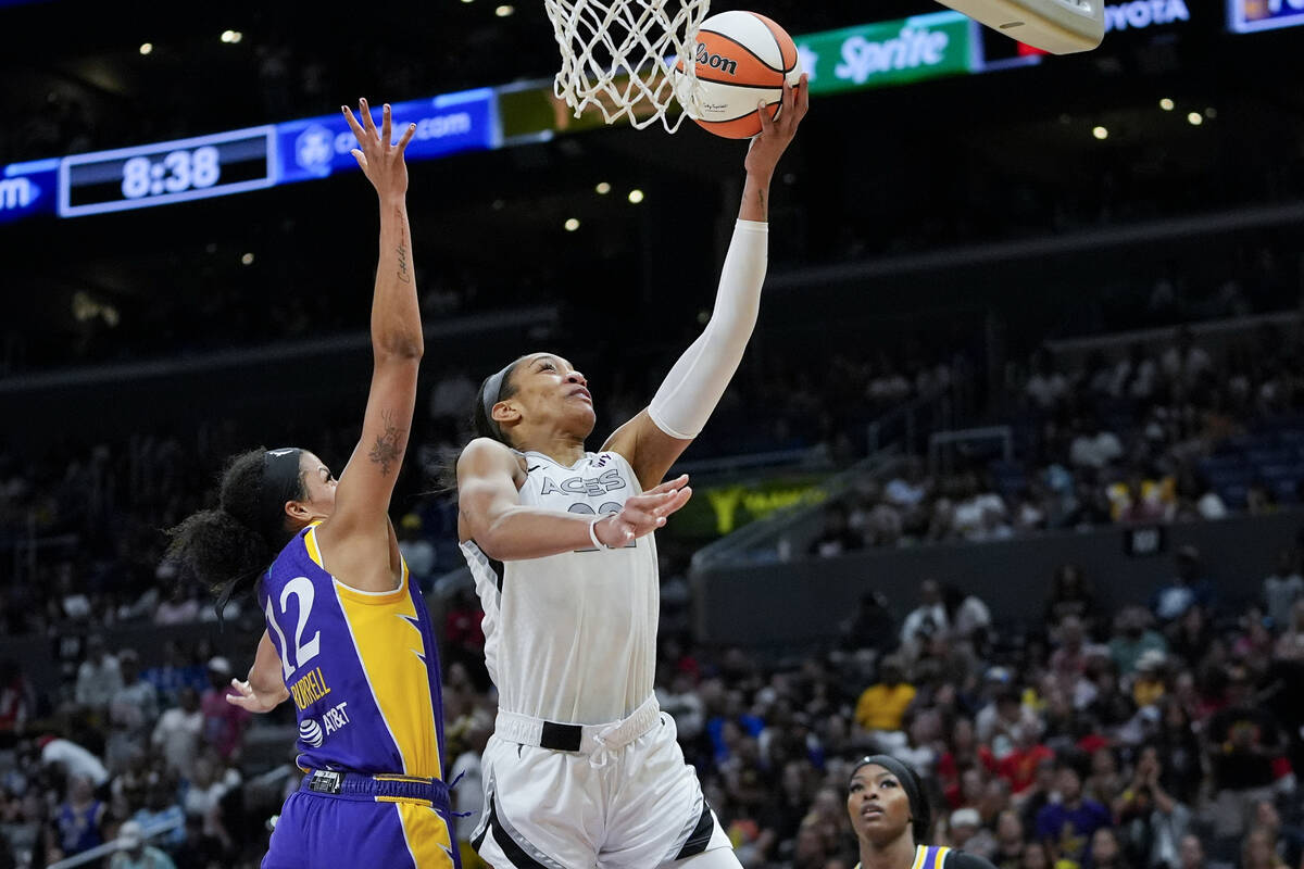 Las Vegas Aces center A'ja Wilson, right, shoots against Los Angeles Sparks guard Rae Burrell d ...