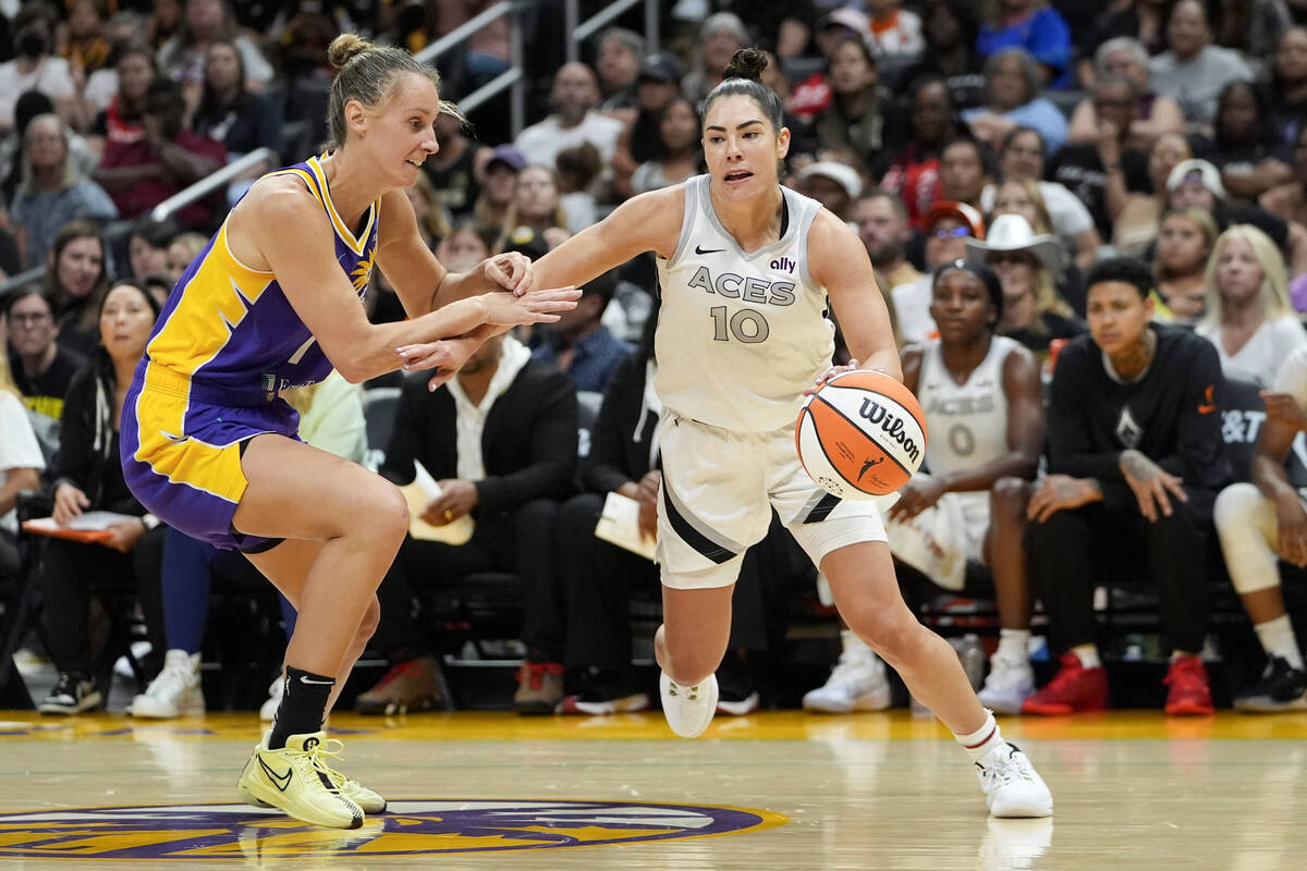 Las Vegas Aces guard Kelsey Plum (10) drives against Los Angeles Sparks forward Stephanie Talbo ...